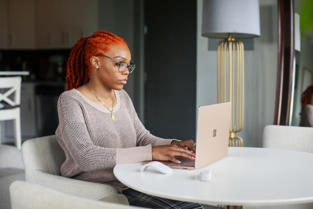 Photo of a Black woman at a computer
